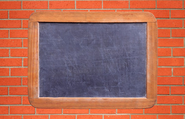 School blackboard over brick wall background
