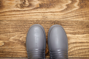 Plastic waterproof boots on a wooden floor