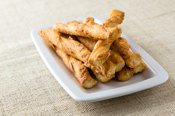 pastry sticks with cheese on white plate