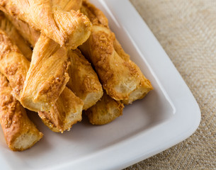 pastry sticks with cheese on white plate