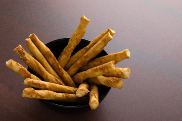 pastry sticks with cheese in a bowl