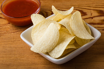 potato chips with dip on a wooden table