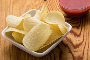 potato chips with dip on a wooden table