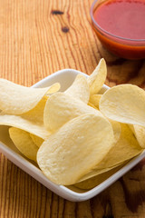 potato chips with dip on a wooden table