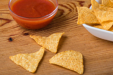tortilla chips with dip on a wooden table