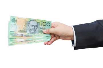 Businessman hand holding Australian dollars (AUD) on isolated background.