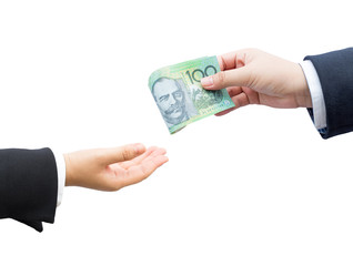 Hands of businessman passing Australian dollar (AUD) banknote on isolated background.