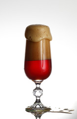 Glass of beer on light background