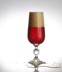 Glass of beer on light background
