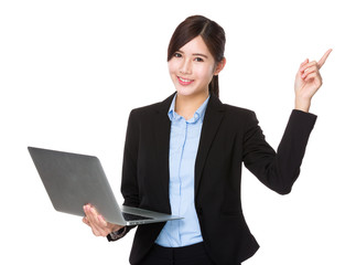 Asian businesswoman use of the laptop computer and finger point