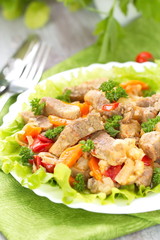 Warm salad with meat and fried vegetables
