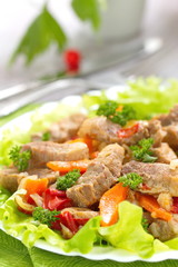 Warm salad with meat and fried vegetables