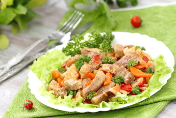 Warm salad with meat and fried vegetables
