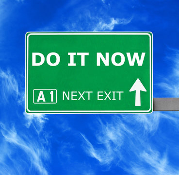 DO IT NOW road sign against clear blue sky