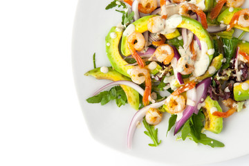 Salad with avocado and shrimp on the white background top view