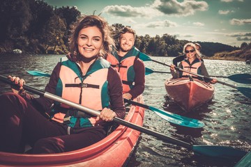 Group of happy people on a kayaks