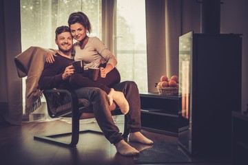 Young couple near fireplace at home