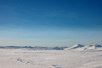 Désert de neige et ciel bleu d& 39 hiver. Des montagnes à l& 39 horizon