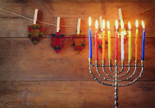 Image of jewish holiday Hanukkah background with menorah (traditional candelabra) and Burning candles

