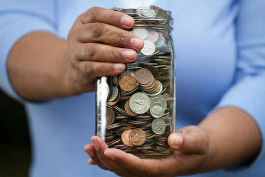 Woman holding a jar of money