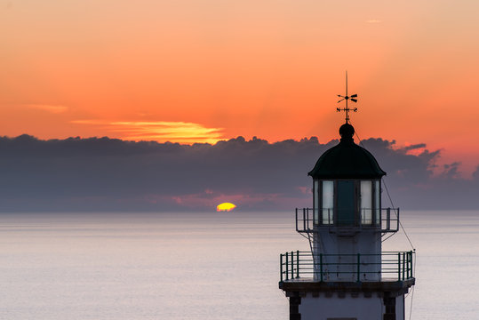 Lighthouse on sunset in Greece