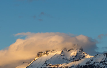 alpine landscape with snow and cloud on top