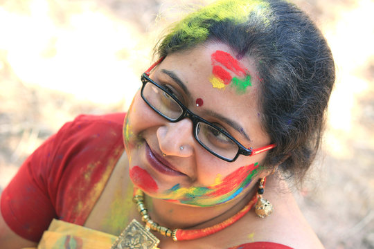 Very beautiful woman is enjoying Holi festival in India.