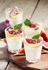 Creamy white yogurt with honey, figs and mint, selective focus