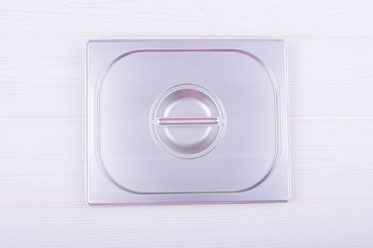 metal lid with handle that comes with food bowls. background. top view.