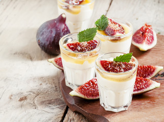 Creamy white yogurt with honey, figs and mint, selective focus