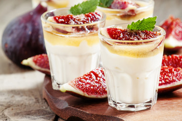 Creamy white yogurt with honey, figs and mint, selective focus
