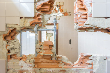 Abandoned and ruined house with big hole in the wall.