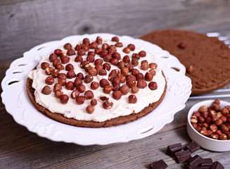 Chocolate cake with nuts on wooden background