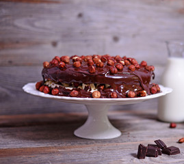 Delicious chocolate cakes with hazelnut on wooden table