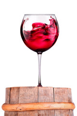 Glass of red wine on a wooden barrel