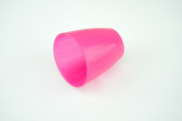 pink plastic mug on white background
