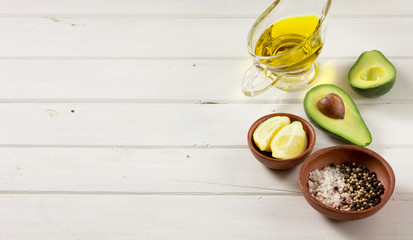 Avocado, and other ingredients for sauce guacamole on the table.