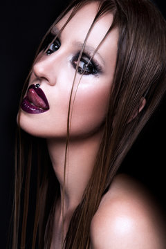 Portrait of gothic girl with blue eyes in dark clothes