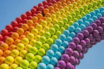 Detail of a rainbow made of balls, showing gay colors