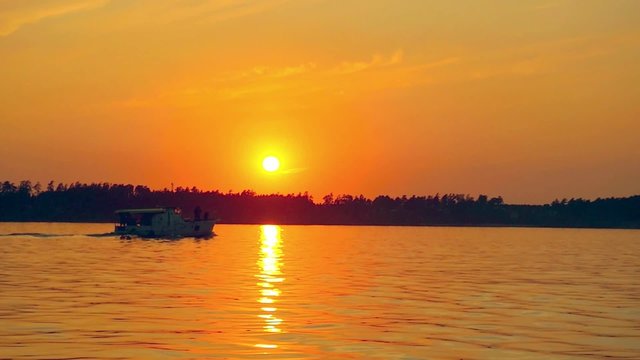 Sailboat against a beautiful sunset in slowmotion
