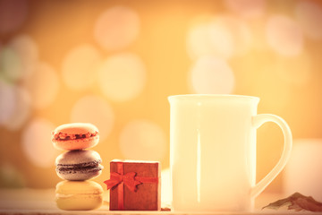 Cup of coffee or tea with macarons