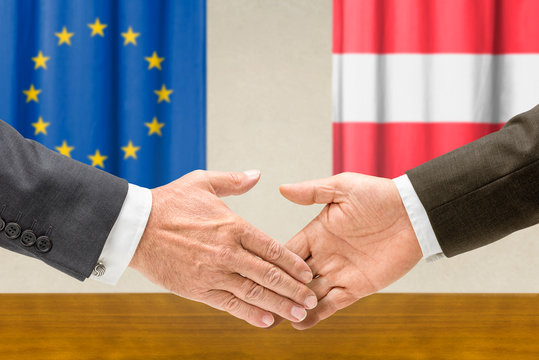 Vertreter der EU und Österreichs reichen sich die Hand