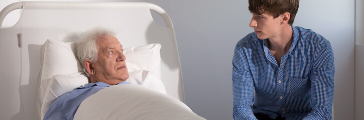 Son visiting father in hospital