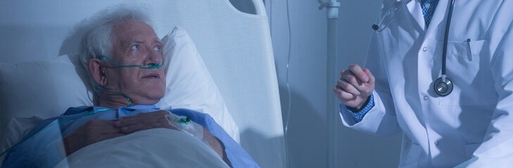 Elder patient looking at doctor