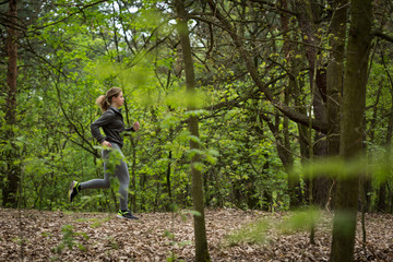 Naklejka na ściany i meble Active runner exercising in nature