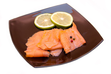 Smoked salmon on black plate on a white background