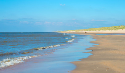 Fototapeta na wymiar Blue sky over a beach along the North Sea