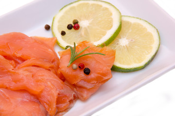 Smoked salmon on tray on white background seen from very close