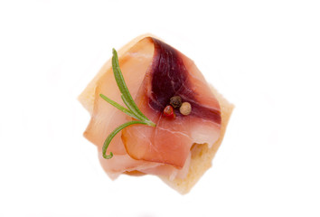 Smoked swordfish on toasted bread on a white background seen from above
