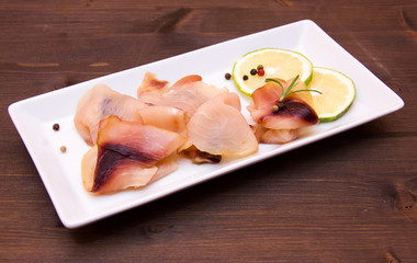 Smoked swordfish on tray on wooden table
